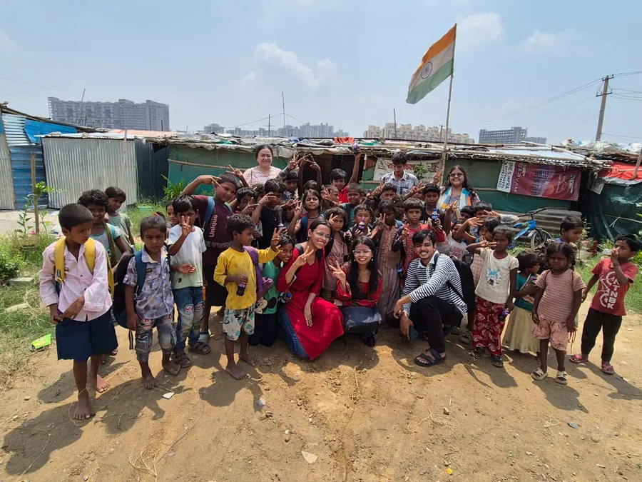 Children and facilitators together outside the learning centre.